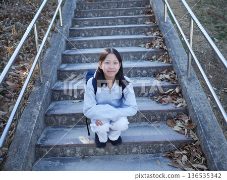 A junior high school girl in a park on a winter day A junior high school girl in a park on a winter day 136535342