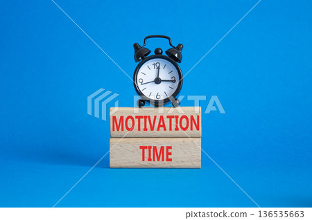 Motivation Time symbol. Concept word Motivation Time on wooden blocks. Beautiful blue background with alarm clock. Business and Motivation Time concept. Copy space 136535663