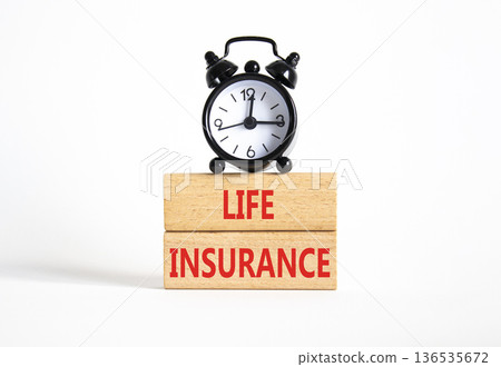 Life insurance symbol. Concept word Life insurance on wooden blocks. Beautiful white background with alarm clock. Business and Life insurance concept. Copy space 136535672