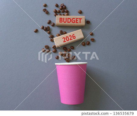 Budget 2026 symbol. Concept words Budget 2026 on beautiful wooden picture frame. Beautiful grey background with coffee cup and coffee beans. Business and Budget 2026 concept. Copy space. Budget 2026 symbol. Concept words Budget 2026 on beautiful wooden picture frame. Beautiful grey background with coffee cup and coffee beans. Business and Budget 2026 concept. Copy space. 136535679