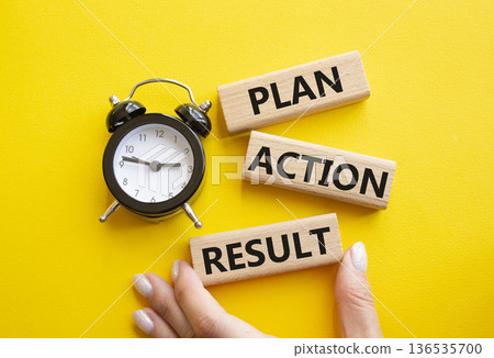 Plan Action Result symbol. Concept words Plan Action Result on wooden blocks. Businessman hand. Beautiful yellow background with alarm clock. Business concept and Plan Action Result. Copy space. Plan Action Result symbol. Concept words Plan Action Result on wooden blocks. Businessman hand. Beautiful yellow background with alarm clock. Business concept and Plan Action Result. Copy space. 136535700