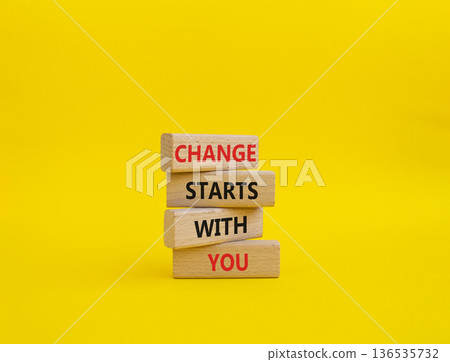 Change symbol. Wooden blocks with words Change Starts With You. Beautiful yellow background. Business and Change concept. Copy space Change symbol. Wooden blocks with words Change Starts With You. Beautiful yellow background. Business and Change concept. Copy space 136535732
