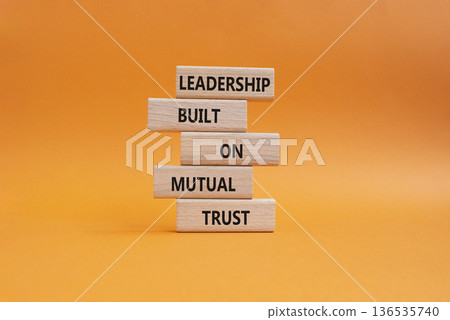 Leadership symbol. Wooden blocks with words Leadership Built on Mutual Trust. Beautiful orange background. Business and Leadership concept. Copy space 136535740