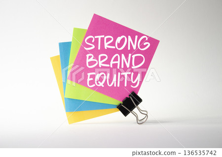 Strong Brand Equity symbol. Concept words Strong Brand Equity on pink sticky note with paper clips. Beautiful white background. Business and Strong Brand Equity concept. Copy space Strong Brand Equity symbol. Concept words Strong Brand Equity on pink sticky note with paper clips. Beautiful white background. Business and Strong Brand Equity concept. Copy space 136535742