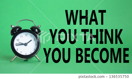 What You think you Become symbol. Wooden blocks with words What You think you Become. Beautiful green background with alarm clock. Business and What You think you Become. Copy space. 136535750