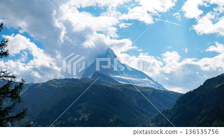 The Matterhorn, a famous mountain in the Alps in summer, its peak covered in thick clouds The Matterhorn, a famous mountain in the Alps in summer, its peak covered in thick clouds 136535756
