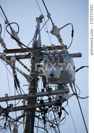 Electric wires and various equipment installed on utility poles in a Japanese city Electric wires and various equipment installed on utility poles in a Japanese city 136535947