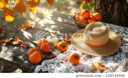 Persimmon with Straw Hat on Rustic Wooden Table in Autumn Persimmon with Straw Hat on Rustic Wooden Table in Autumn 136536466