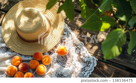 Apricots with Straw Hat on Rustic Wooden Table Apricots with Straw Hat on Rustic Wooden Table 136536475
