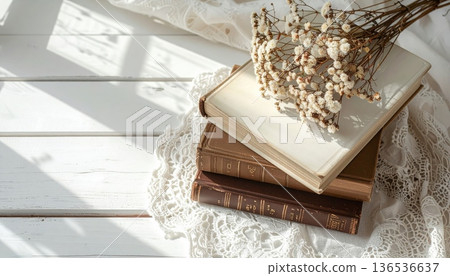 Vintage White and Brown Book Stack on White Desk with Lace Cloth Vintage White and Brown Book Stack on White Desk with Lace Cloth 136536637