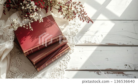 Vintage Red and Brown Book Stack on White Desk with Lace Cloth Vintage Red and Brown Book Stack on White Desk with Lace Cloth 136536640