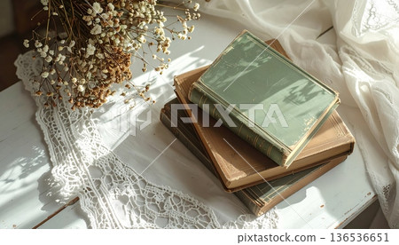 Vintage Green and Brown Book Stack on White Desk with Lace Cloth 136536651
