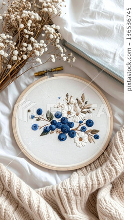 Embroidered Blueberry Hoop on Bed with Knitted Blanket Book and White Dried Flowers Embroidered Blueberry Hoop on Bed with Knitted Blanket Book and White Dried Flowers 136536745