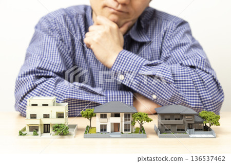 Man choosing a house Man choosing a house 136537462