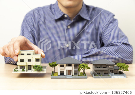 Hands of a man choosing a house 136537466