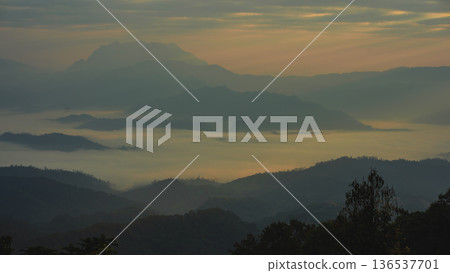 sunrise with moving of cloud and clear sky and layer of mountain 136537701