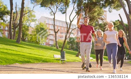 Group of active seniors running while taking a selfie Group of active seniors running while taking a selfie 136538114
