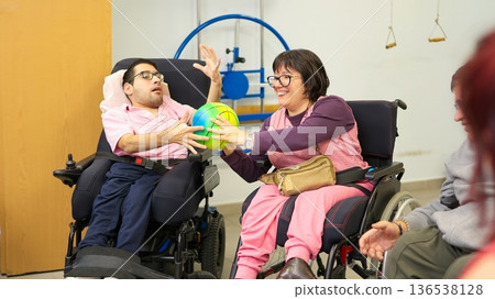 Individuals with physical disabilities playing ball activity supporting inclusion Individuals with physical disabilities playing ball activity supporting inclusion 136538128
