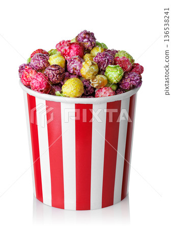 Caramelized fruit popcorn in red and white striped paper cup isolated on white 136538241
