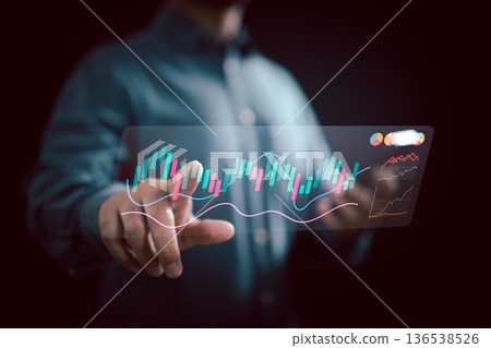Businessman interacting with futuristic digital stock market graph and financial charts on transparent screen Businessman interacting with futuristic digital stock market graph and financial charts on transparent screen 136538526