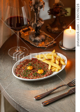 Beef tartare with egg yolk and french fries Beef tartare with egg yolk and french fries 136539228
