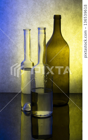 Still life with glassware on a colored background Still life with glassware on a colored background 136539618
