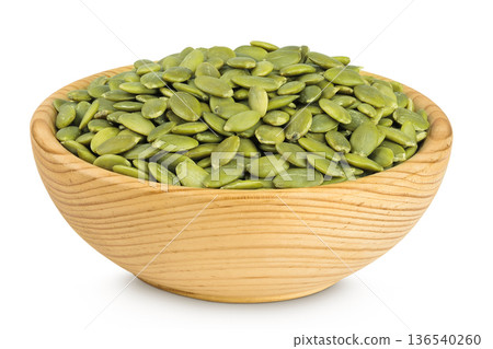Peeled pumpkin seeds in wooden bowl isolated on white background 136540260