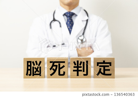 一塊寫著「腦死判定」的牌子，旁邊是一位醫生 136540363