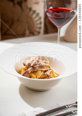 Italian pasta with beef strips and parmesan 136540895