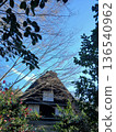 A Japanese house with a thatched roof and blue sky | A traditional old house surrounded by nature 136540962