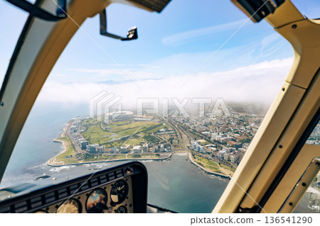 Aerial view of Cape Town cityscape and ocean from a helicopter. Scenic urban landscape with stadium and coastline. Luxury travel concept. 136541290