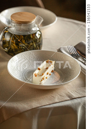 Creamy dessert slice served with tea and coffee 136541533
