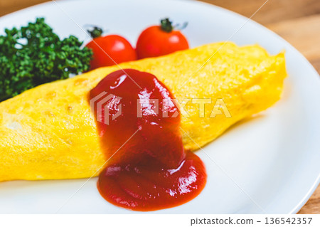 Omurice: A classic Western dish of fluffy eggs topped with ketchup Omurice: A classic Western dish of fluffy eggs topped with ketchup 136542357