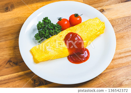 Omurice: A classic Western dish of fluffy eggs topped with ketchup Omurice: A classic Western dish of fluffy eggs topped with ketchup 136542372