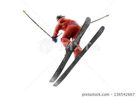 Skier in flight. Bottom view. Jump. Sportsman in a red ski suit. Skiing in action. rear view. High speed. Isolated 136542667