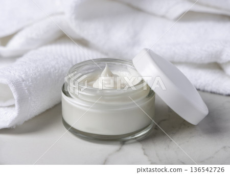 Mockup of opened face cream jar with blank lid on stone, unbranded cosmetic packaging in spa hotel bathroom Mockup of opened face cream jar with blank lid on stone, unbranded cosmetic packaging in spa hotel bathroom 136542726