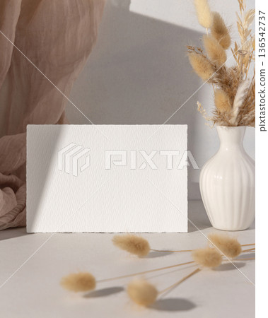 Mockup of blank card with beige and brown natural decor, boho wedding stationery, hard shadows Mockup of blank card with beige and brown natural decor, boho wedding stationery, hard shadows 136542737