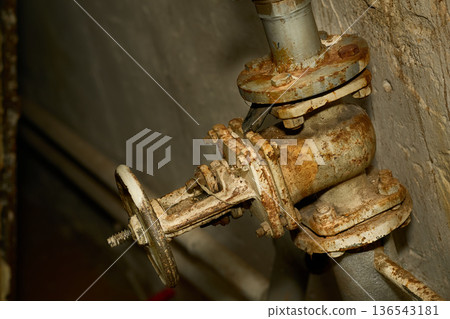 Plumbing water valve,old rusty faucet in basement 136543181