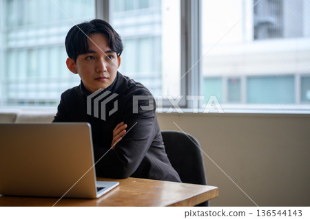 A man pondering by the window A man pondering by the window 136544143