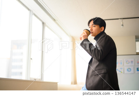 A man resting by the window A man resting by the window 136544147