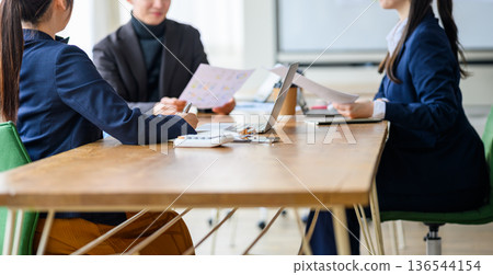 Reviewing documents at a meeting 136544154