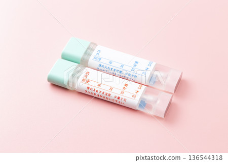 Colon cancer stool test kit on a pink background 136544318