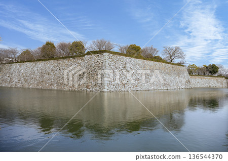 A winter moat scene with a blue sky A winter moat scene with a blue sky 136544370