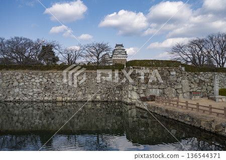 A winter moat scene with a blue sky A winter moat scene with a blue sky 136544371