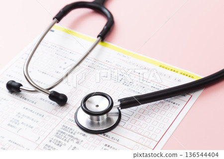 Medical questionnaire and stethoscope on a pink background Medical questionnaire and stethoscope on a pink background 136544404