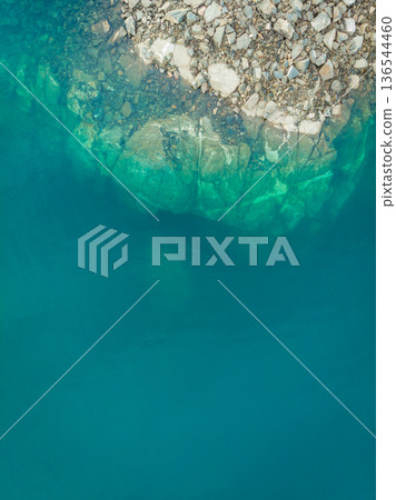 Blue water and rocks, view from above Blue water and rocks, view from above 136544460