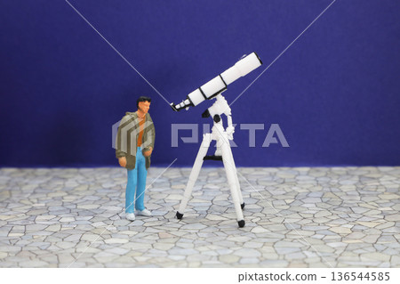 Man gazing into a telescope Man gazing into a telescope 136544585
