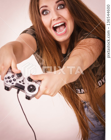 Gamer woman holding gaming pad Gamer woman holding gaming pad 136544600