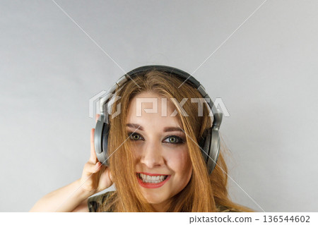 Teen women wearing headphones Teen women wearing headphones 136544602