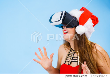 Girl watching 3d film tour in virtual reality glasses. 136544653